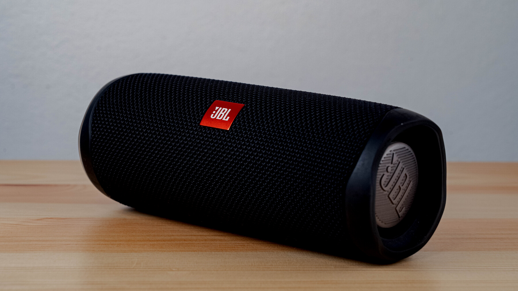 Black JBL Portable Speaker on Brown Wooden Table